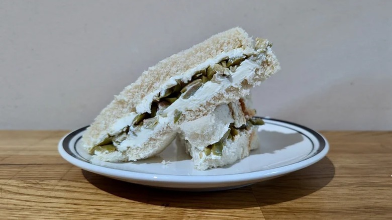 Cream cheese and olive sandwich on white bread cut in half
