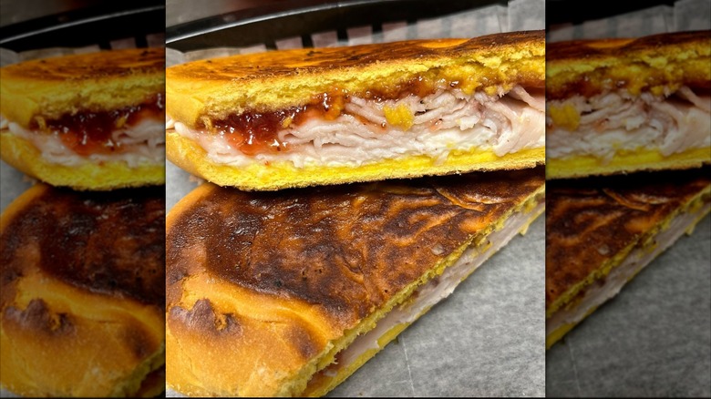 Toasted Elena Ruz sandwich cut in half in basket