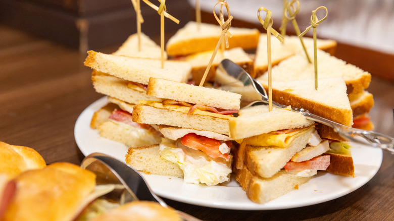 Tramezzini half sandwiches on plate with sandwich picks