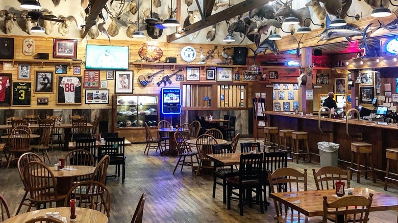 Interior of Granzella's restaurant with wooden tables, taxidermy, and sports memorabilia
