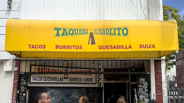 Yellow Taqueria El Farolito awning above storefront on sunny day