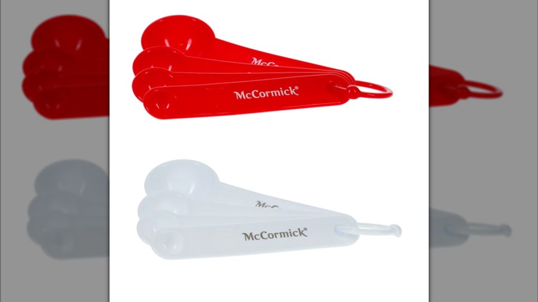 A set of red and a set of white Dollar Tree McCormick measuring spoons