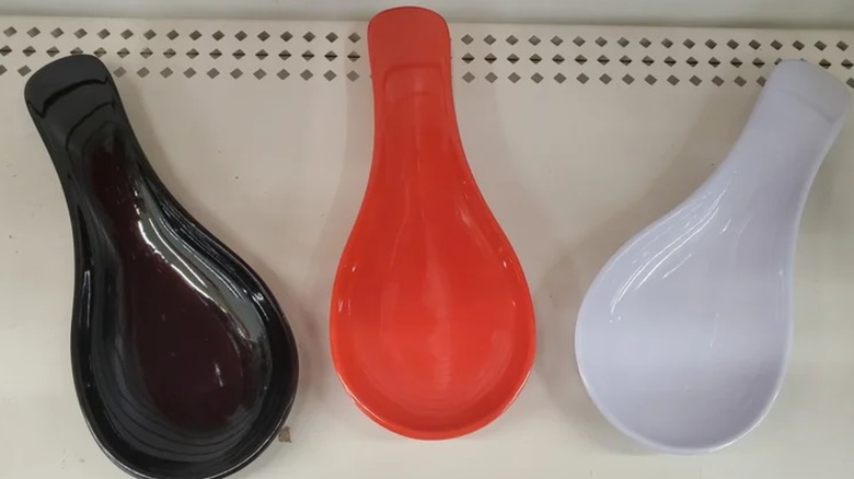 Three Dollar Tree spoon rests on store shelf, one black, one red, and one white