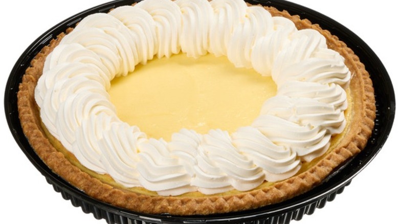 Kirkland Signature Lemon Custard Pie in a black plastic pie plate on a white background.