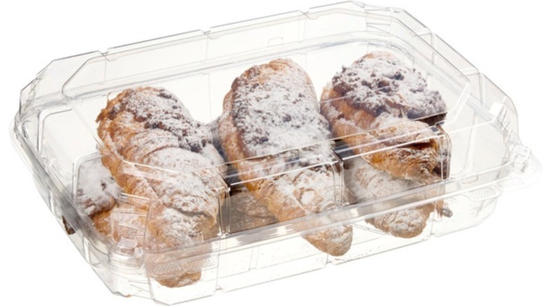 Kirkland Signature Twice-Baked Chocolate Filled Croissants in clear plastic clamshell packaging on a white background.