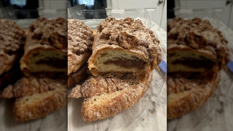 Kirkland Signature Twice-Baked Cinnamon-Filled Croissants in an opened clear plastic clamshell package on a beige tablecloth
