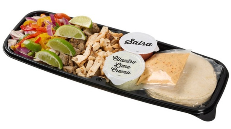 Kirkland Signature Beef and Chicken Fajita Kit in a black plastic tray on a white background.