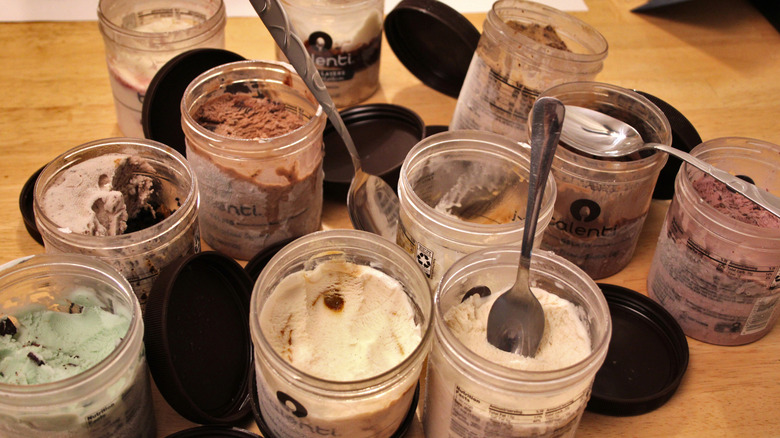 An array of opened pints of Talenti Gelato scattered across a table.