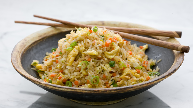 Bowl of fried rice with chopsticks