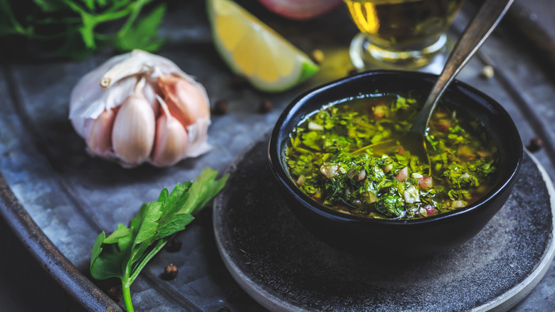 A bowl of chimichurri styled with fresh ingredients