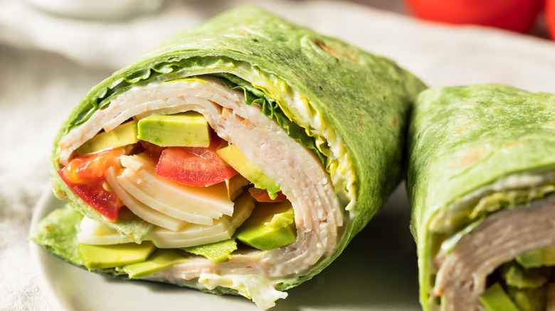 Turkey spinach wrap with avocado and tomato