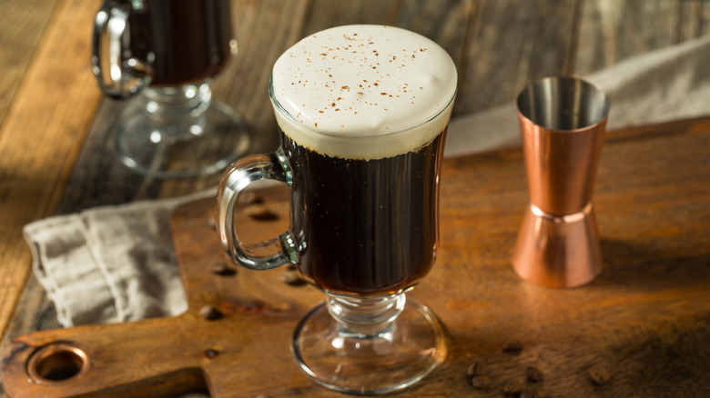 irish coffee on cutting board with jigger