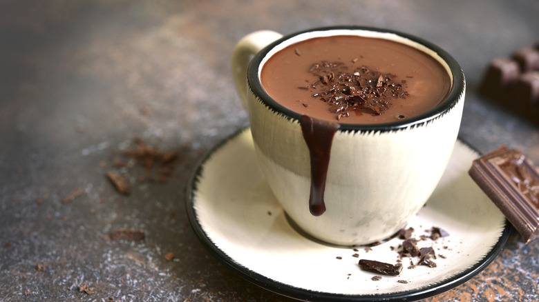 closeup of a white mug with thick chocolate drip