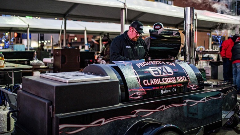 Man tending the Clark Crew BBQ pit in competition