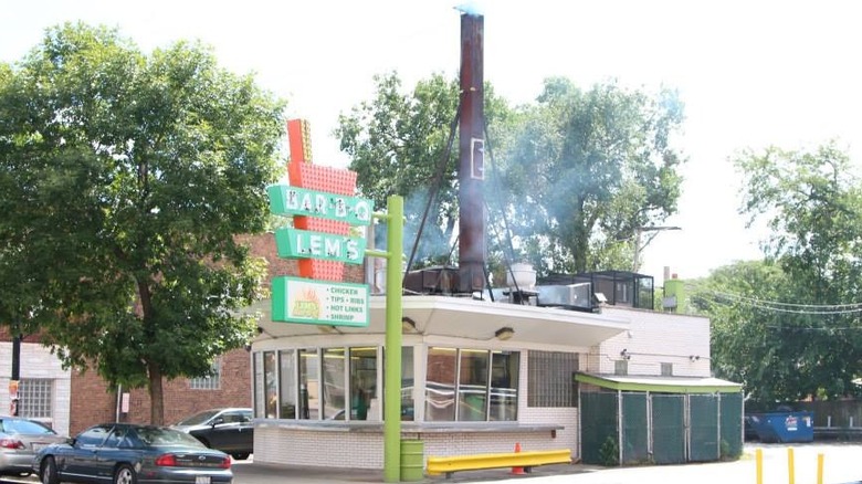 Small white building with a smokestack on the roof and a marquee sign