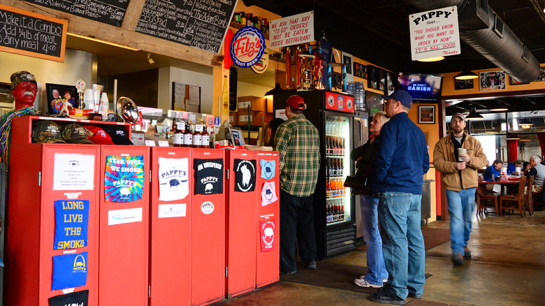 Customers study a chalkboard menu at Pappy's