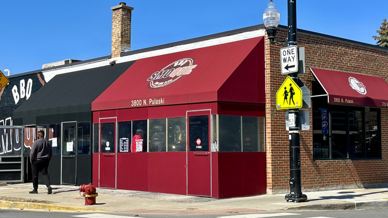 Brick building with a red awning that says Smoque BBQ