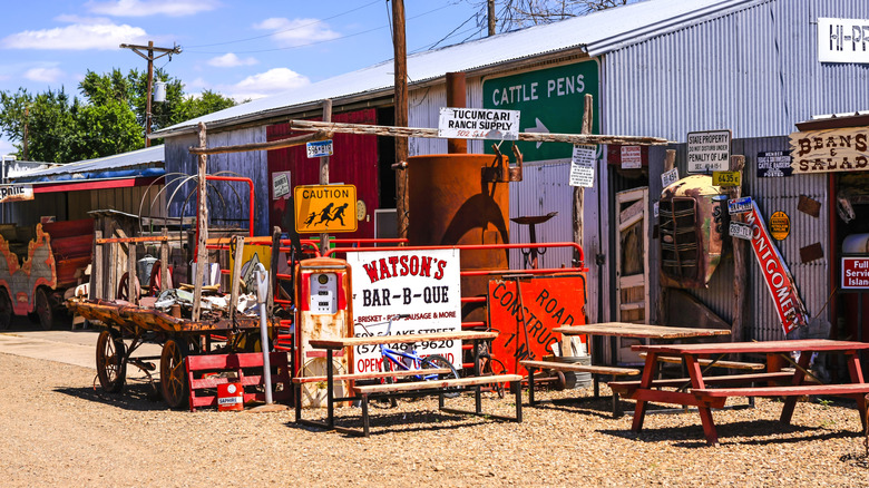Picnic tables by a shed with vintage ranch supplies