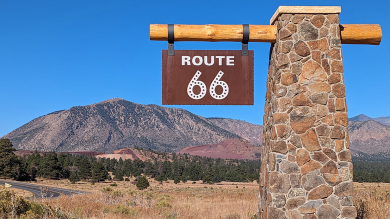 Route 66 road sign in New Mexico with a mountain in the background