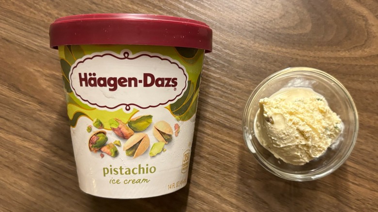 Häagen-Dazs Pistachio Ice Cream carton next to ice cream in glass ramekin