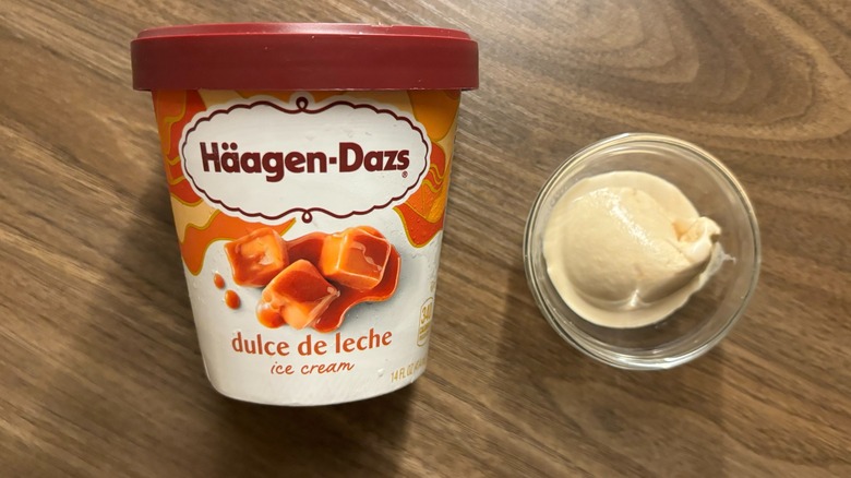 Häagen-Dazs Dulce de Leche Ice Cream carton next to ice cream in glass ramekin