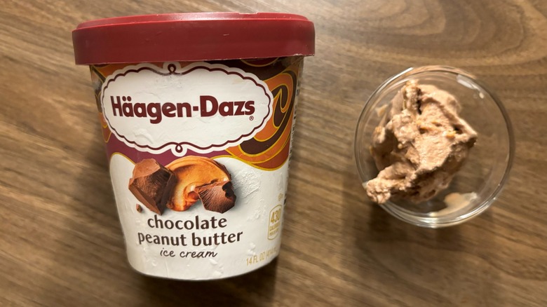 Häagen-Dazs Chocolate Peanut Butter Ice Cream carton next to ice cream in glass ramekin