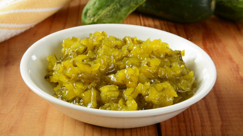 A white bowl of relish on a counter