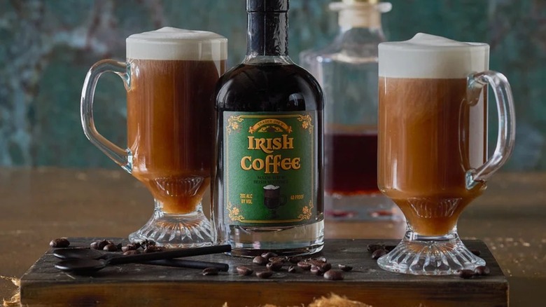 Trader Joe's ready-to-drink Irish coffee in two glass mugs with the bottle in between