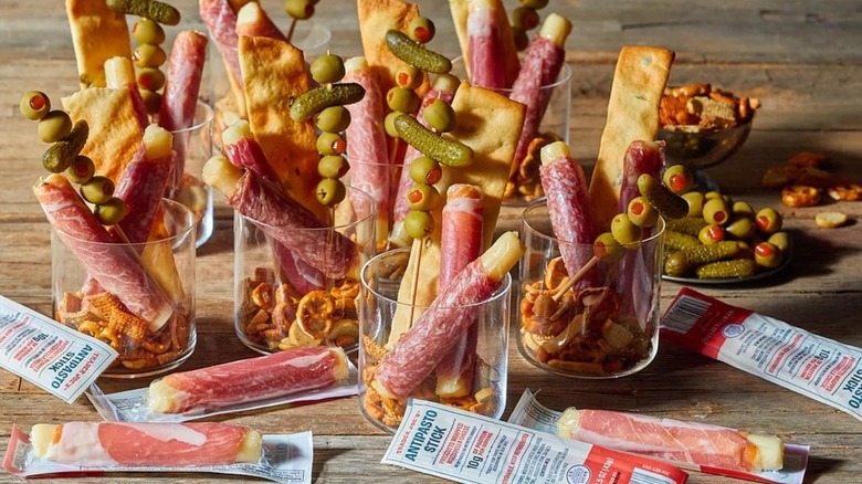 Trader Joe's antipasto sticks with pickles and olives in clear cups