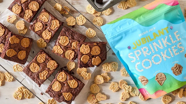 Trader Joe's Jubilant Sprinkle cookies placed on top of baked brownies next to bag of cookies