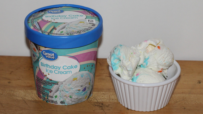 Great Value birthday cake ice cream container with a bowl of scooped ice cream beside it