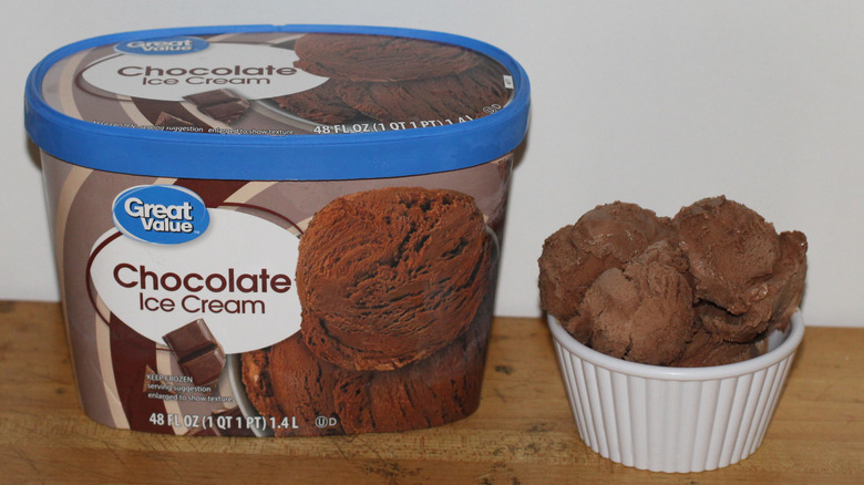 Great Value chocolate ice cream container with a bowl of scooped ice cream beside it