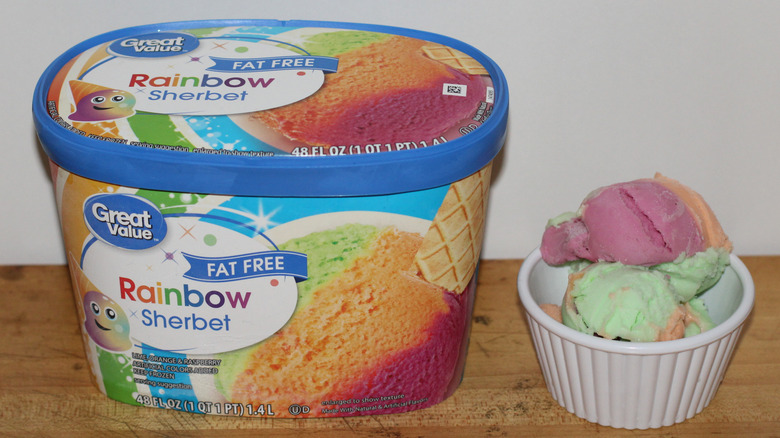 Great Value fat-free rainbow sherbet container with a bowl of scooped ice cream beside it