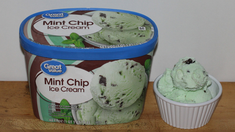 Great Value mint chip container with a bowl of scooped ice cream beside it