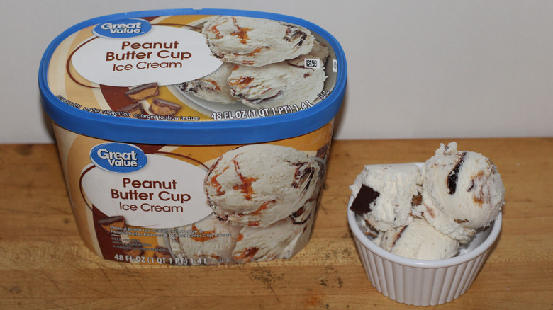 Great Value peanut butter cup ice cream container with a bowl of scooped ice cream beside it