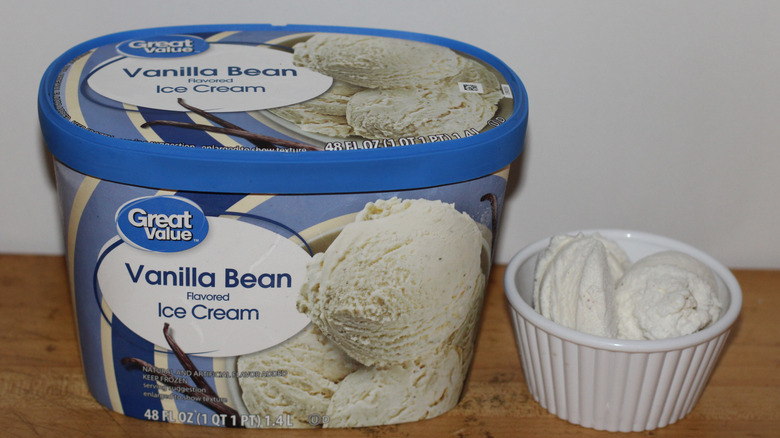 Great Value vanilla bean flavored ice cream container with a bowl of scooped ice cream beside it