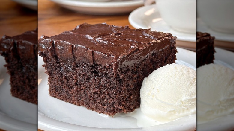 A slice of double chocolate fudge Coca-Cola cake with a scoop of ice cream