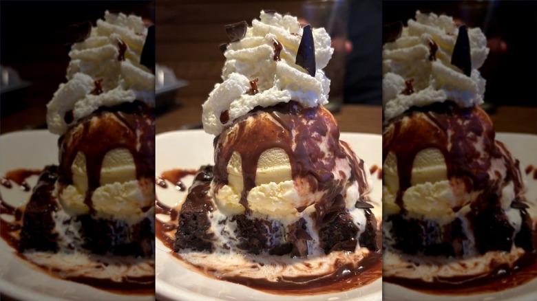 The Chocolate Thunder From Down ﻿Under brownie stacked with ice cream, cream, and chocolate sauce