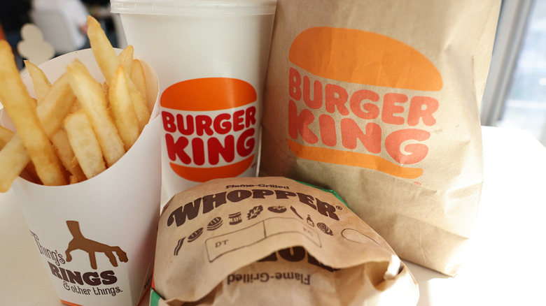 Close up of a Burger King meal with drink, bag, burger, and fries