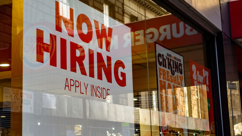 Now Hiring sign on Burger King window