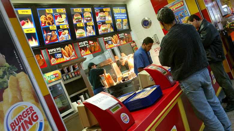 People standing at a Burger King counter in Israel