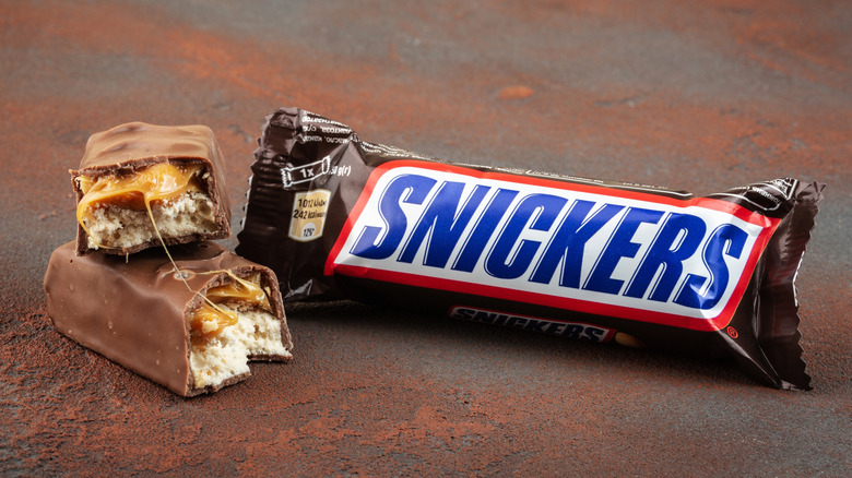 Wrapped and unwrapped Snickers candy bar