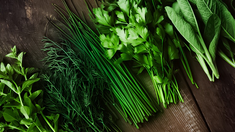 fresh herbs lay flat on a wooden coutnertop