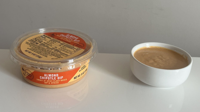 A tub and bowl of Trader Joe's Almond Chipotle Dip
