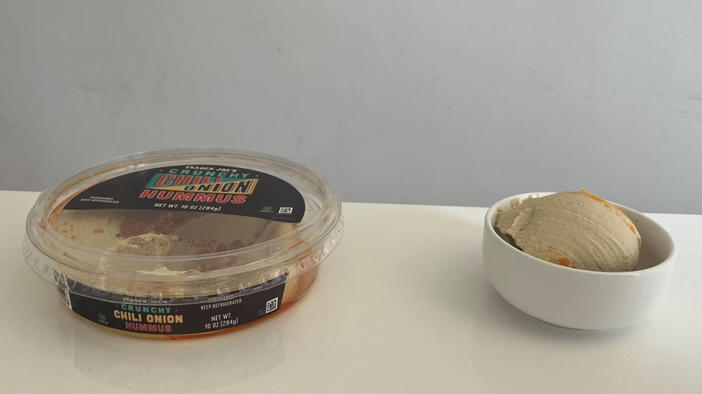 A container of Trader Joe's Crunchy Chili Onion Hummus