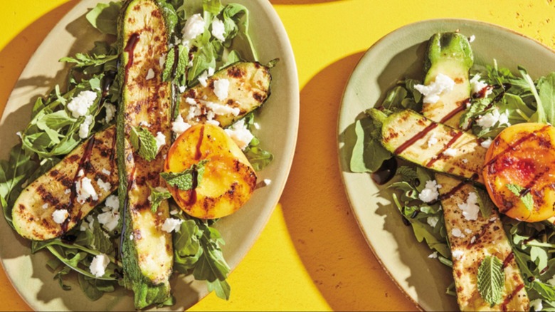 Plates of grilled zucchini and peaches