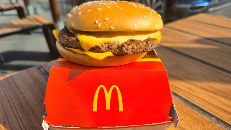 A Quarter Pounder sitting atop a McDonald's box, with logo displayed.