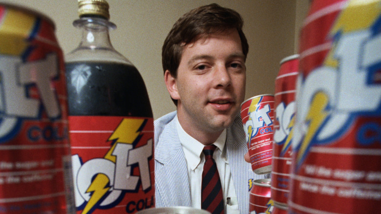 CJ Rapp surrounded by Jolt Cola cans and bottles