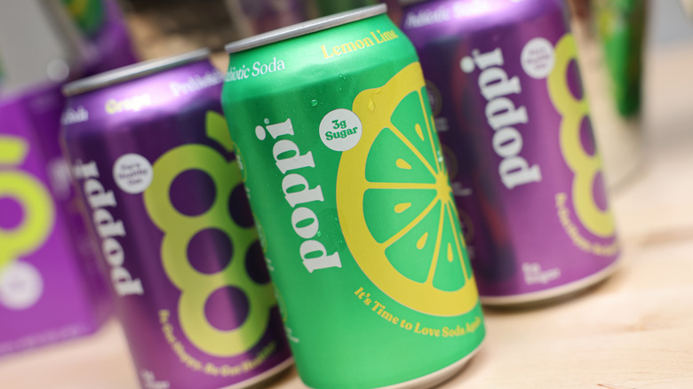 A group of Poppi prebiotic soda cans sitting on a table.