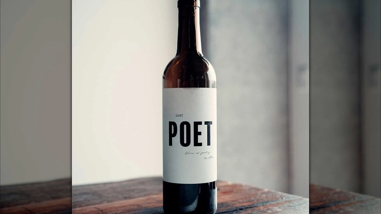 A bottle of Lost Poet Red Wine on a wooden table